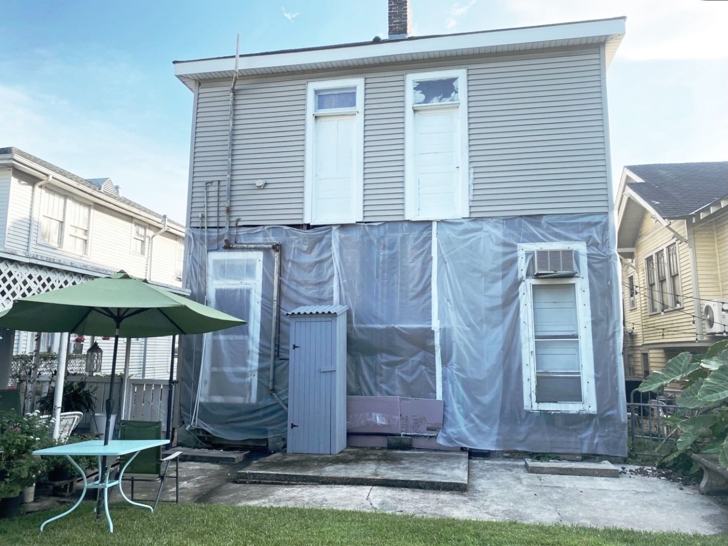 Before — rear of home during renovation wrap