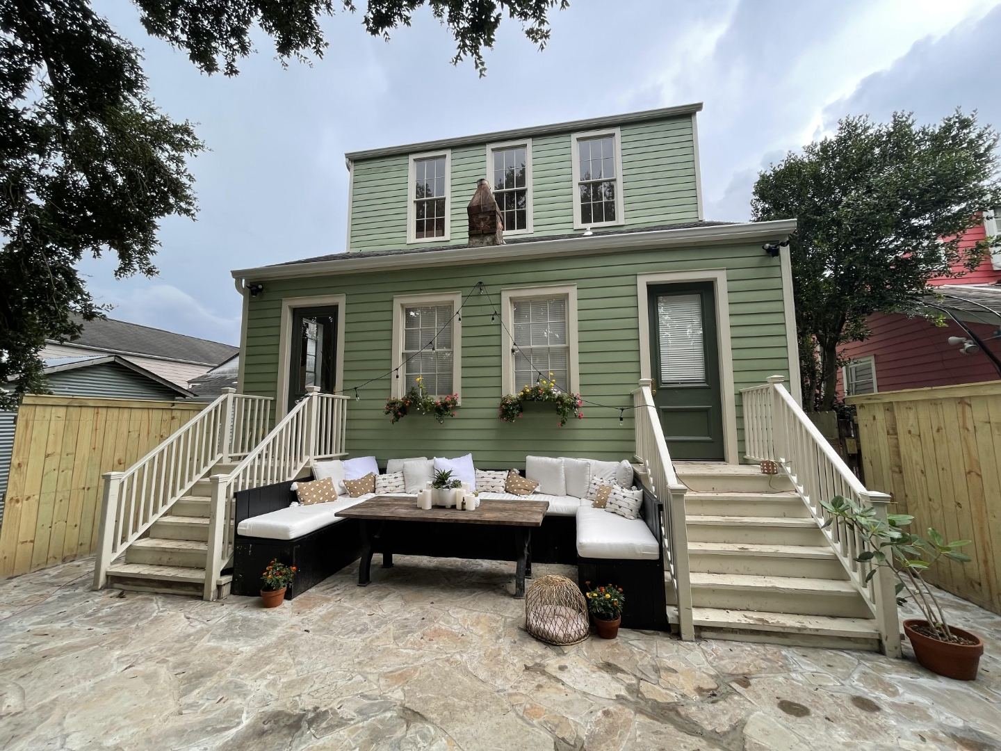 Completed exterior renovation with flagstone patio and outdoor living