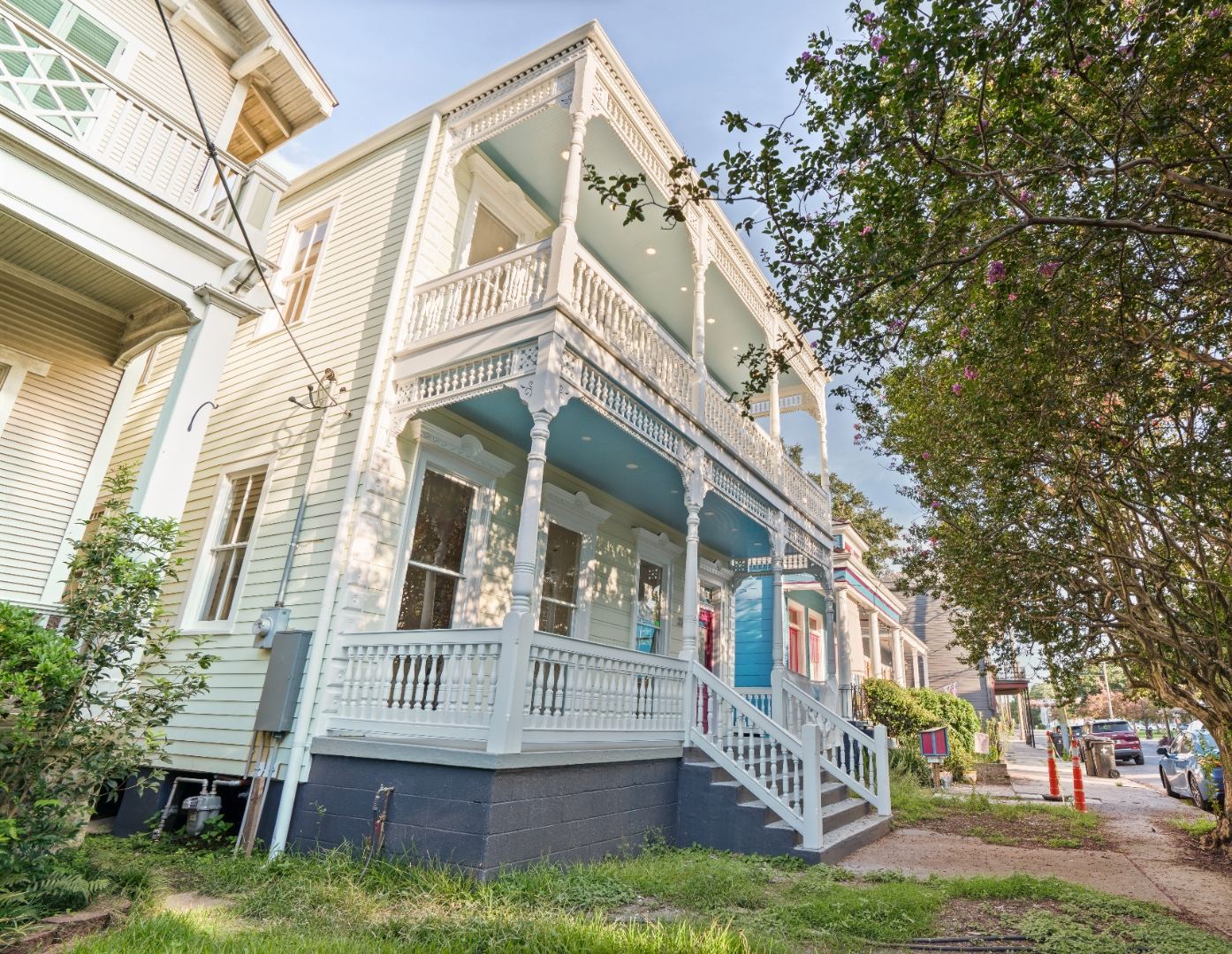 After — fully restored Victorian home with haint blue porches