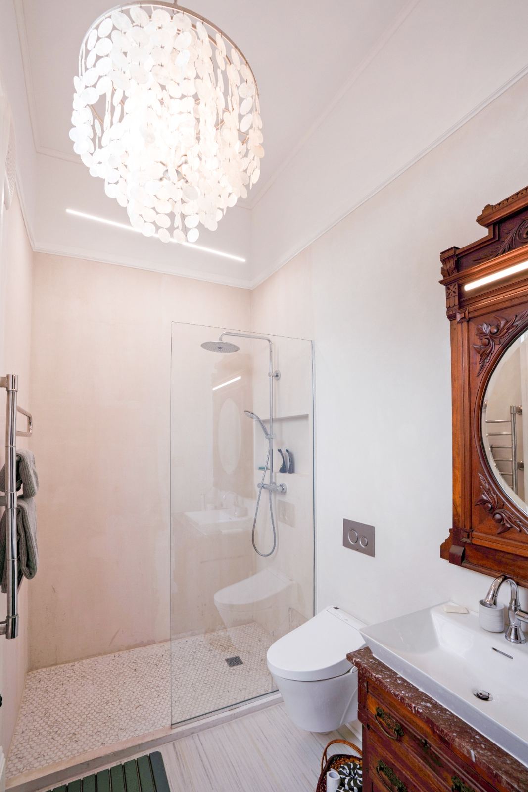 Ornate antique carved mirror reflecting walk-in shower
