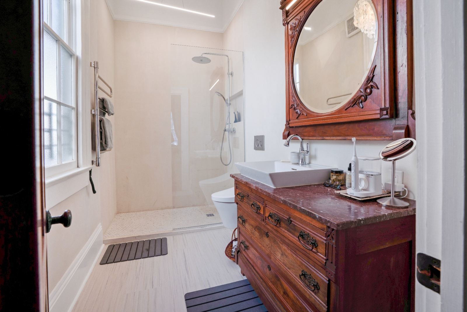Full master bath with antique vanity and rain shower