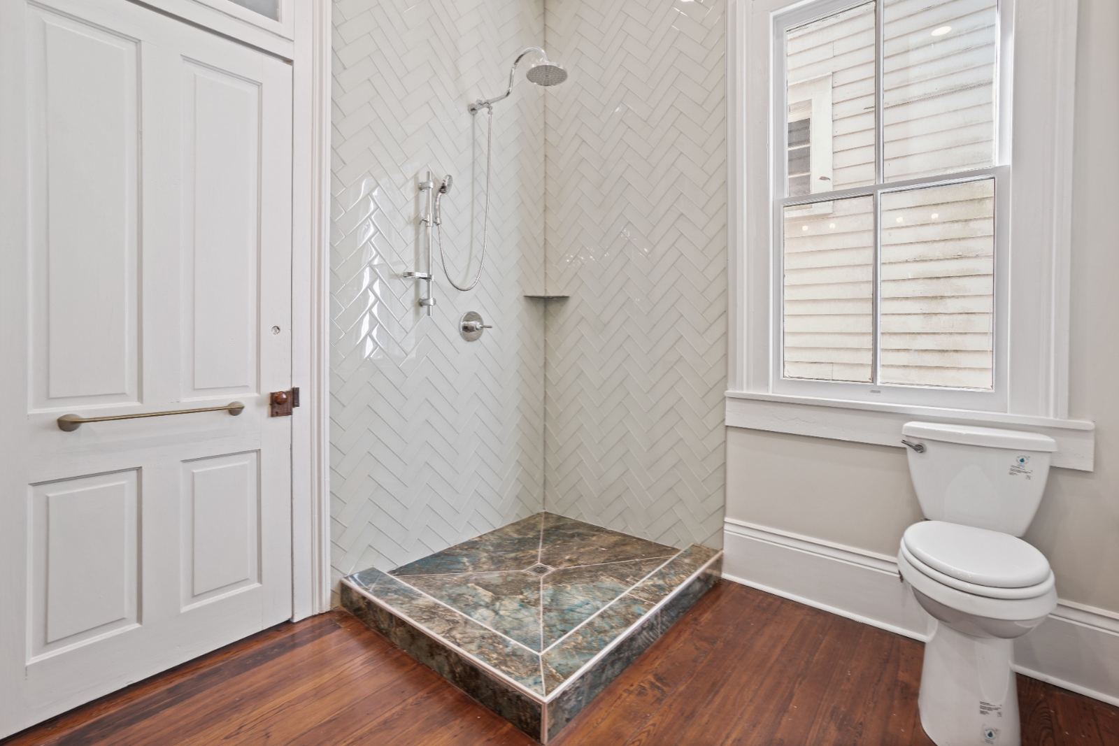 White herringbone shower with labradorite stone base