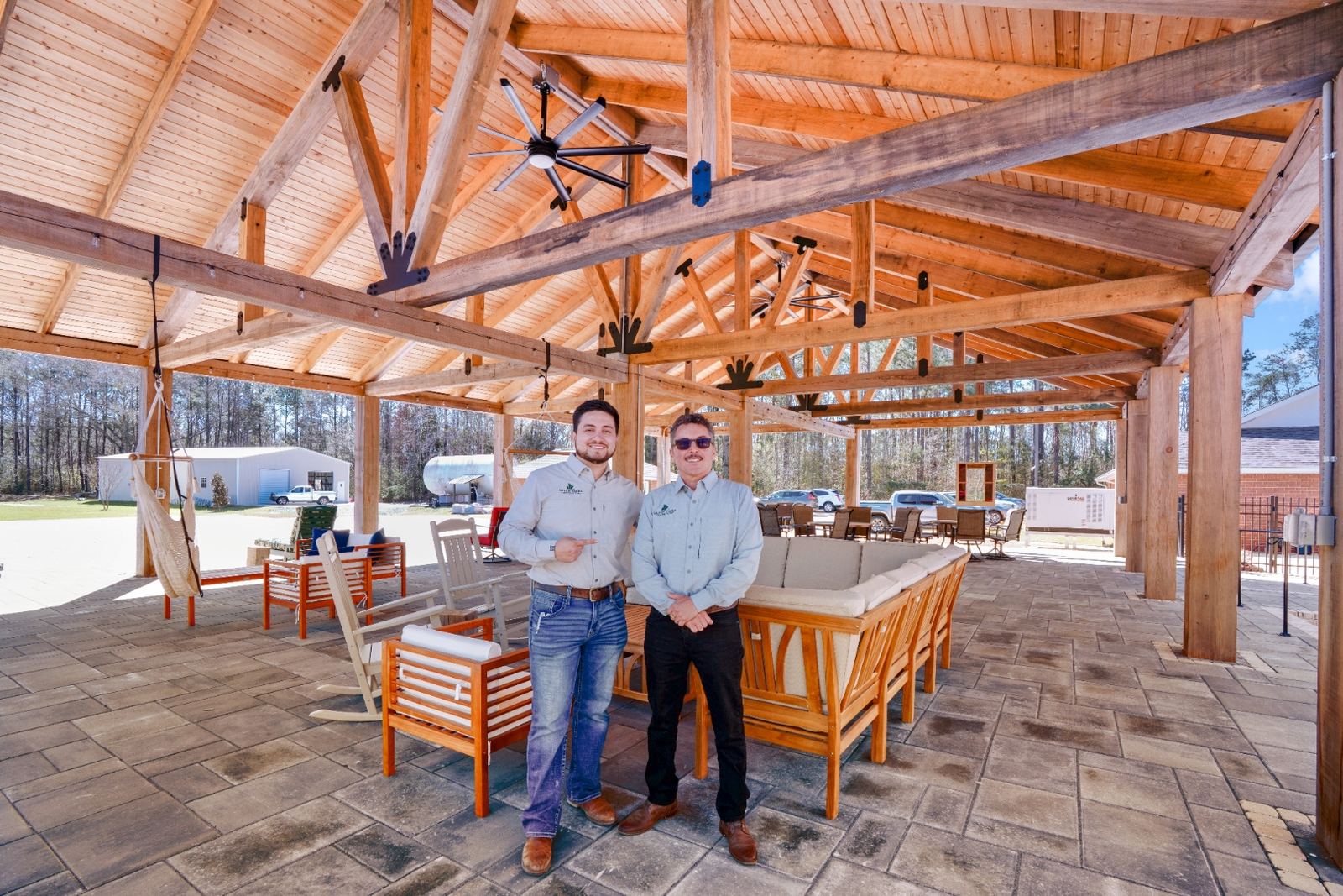 Rey and Esteban Rivas under completed timber frame pavilion