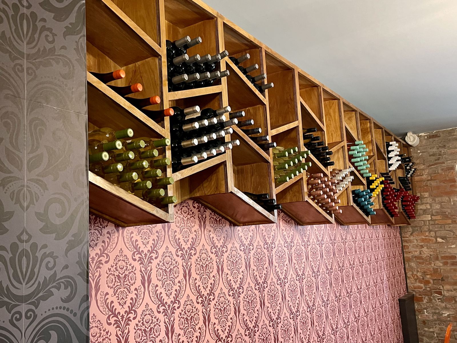 Restaurant dining room angle showing red velvet drapes and custom millwork