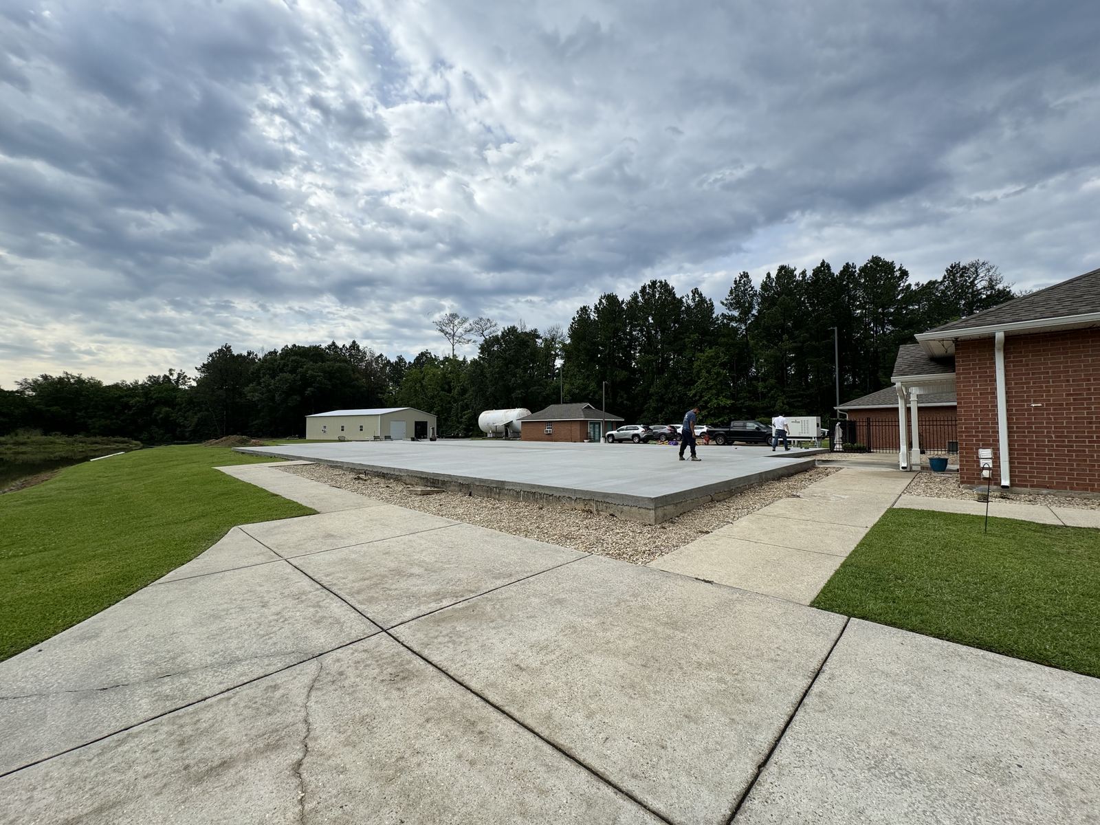 Floor-to-ceiling custom wood wine rack wall with damask wallpaper