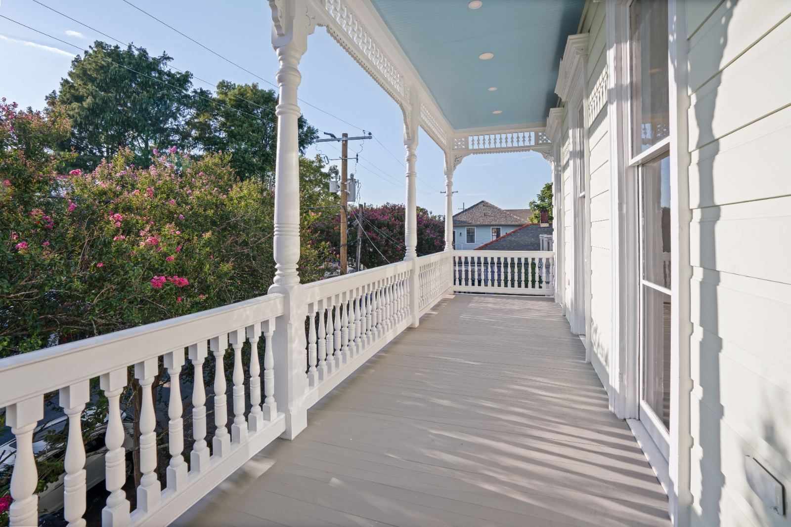 Restored upper porch with crepe myrtle and New Orleans street view