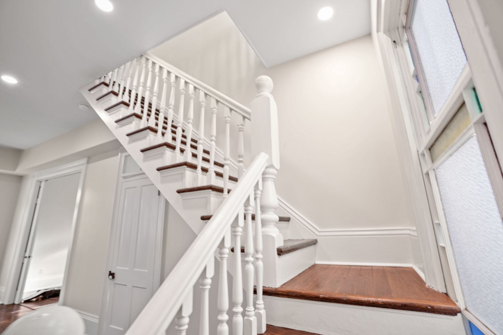 Restored Victorian double shotgun from street corner showing full facade