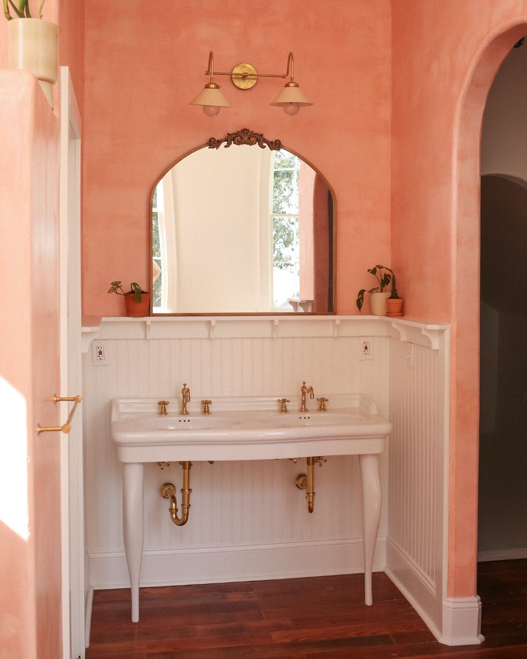 Pink vanity with brass fixtures