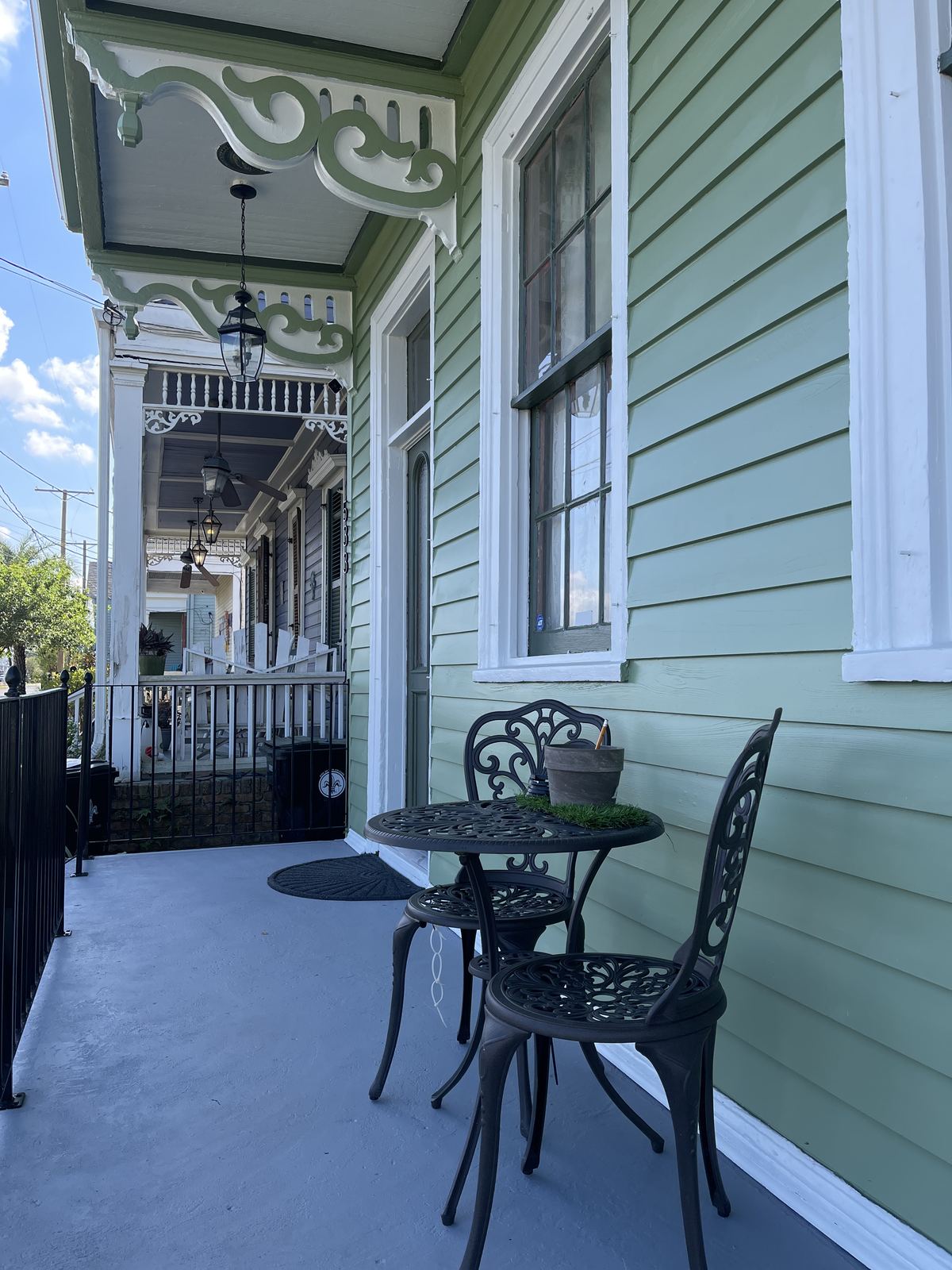 Restored shotgun porch with ornate millwork