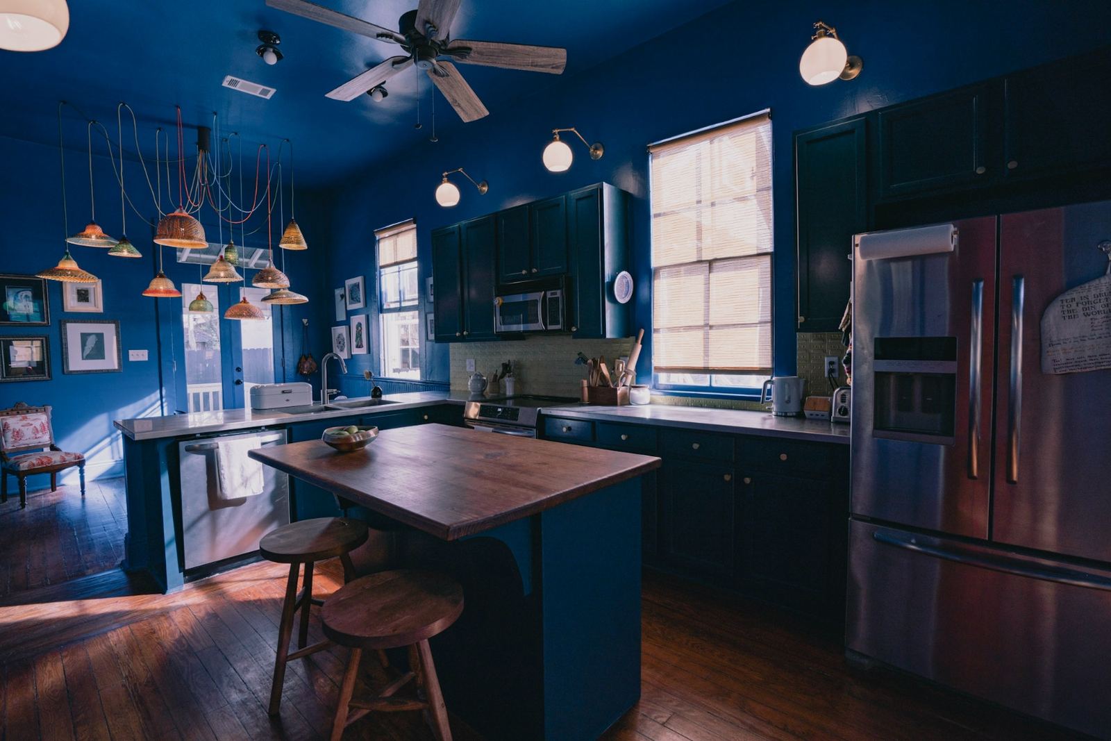 Indigo blue kitchen with cassette tape ceramic backsplash tile and steel counters