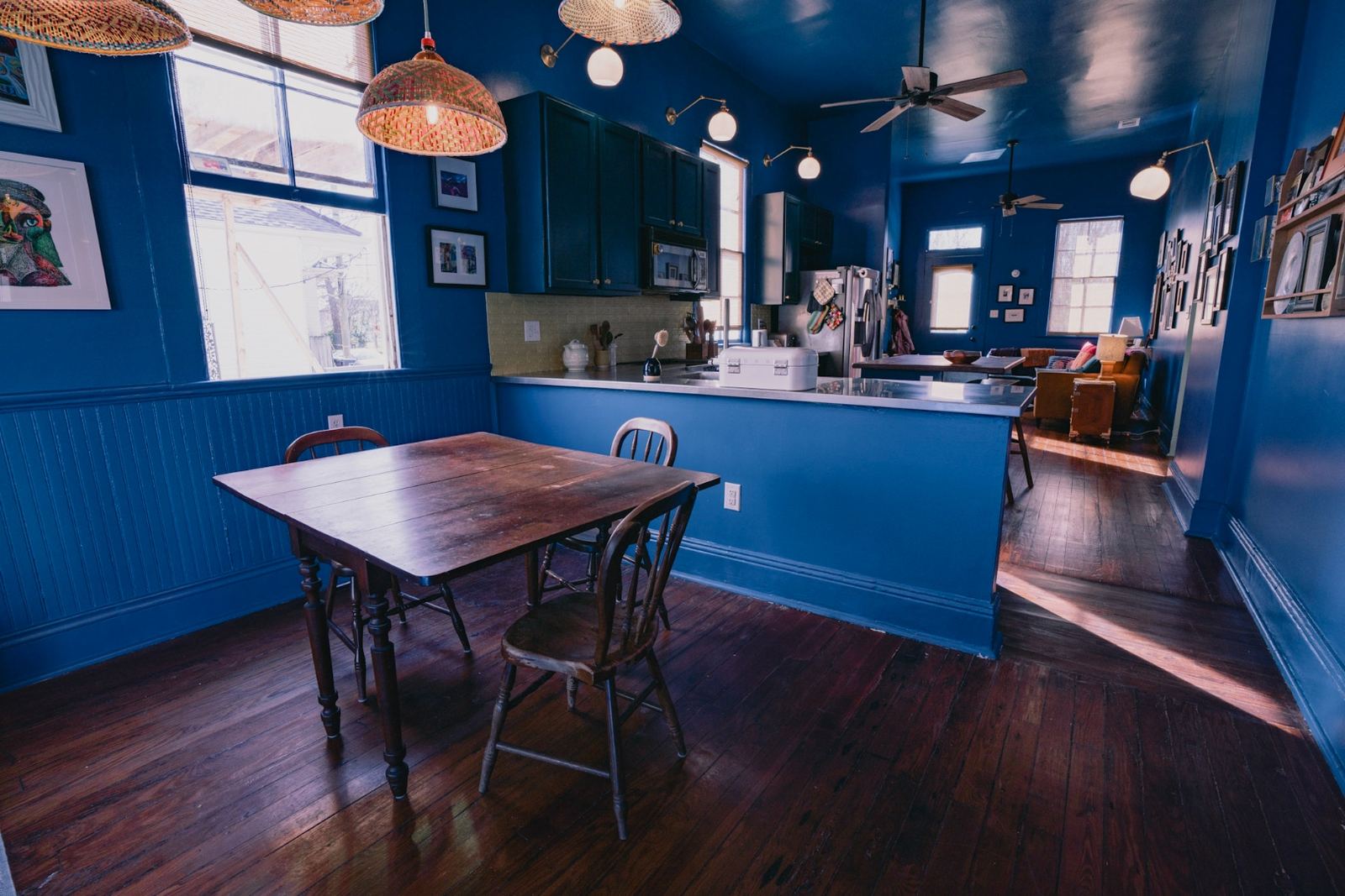 Full shotgun floor plan view from kitchen through to blue living room
