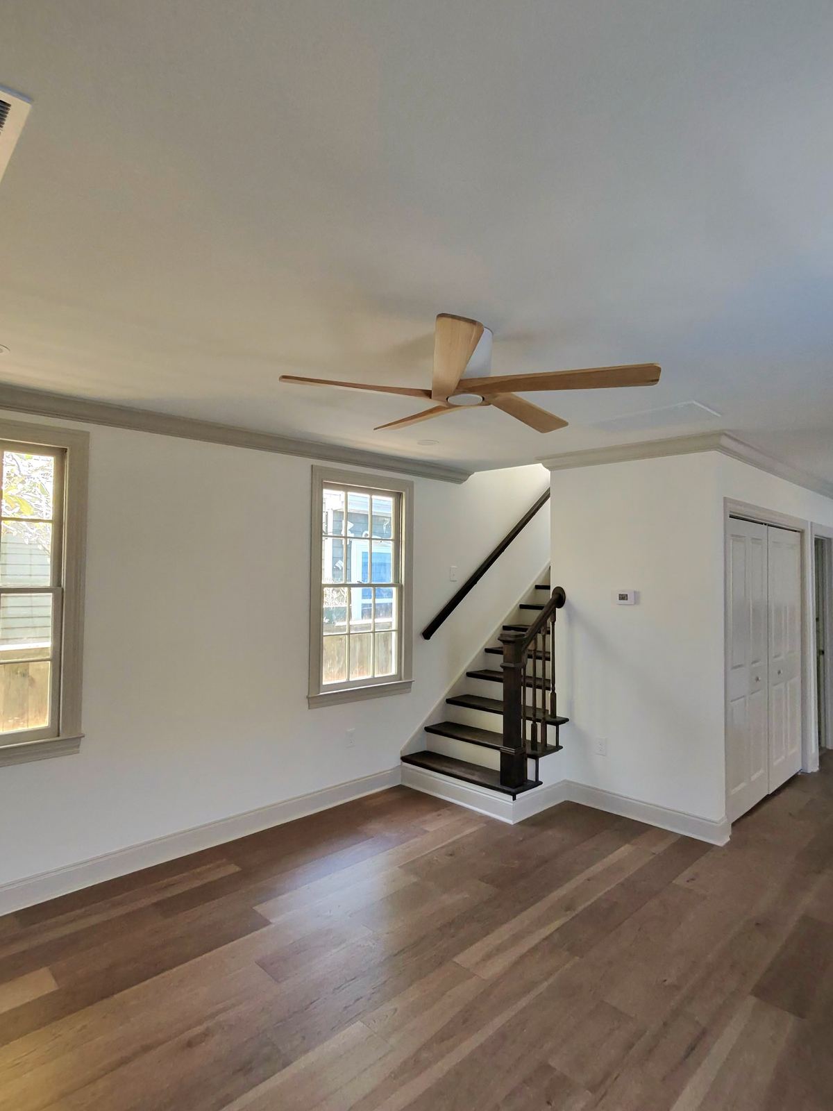 New construction kitchen with blue subway tile backsplash, marble counters and built-in wine fridge
