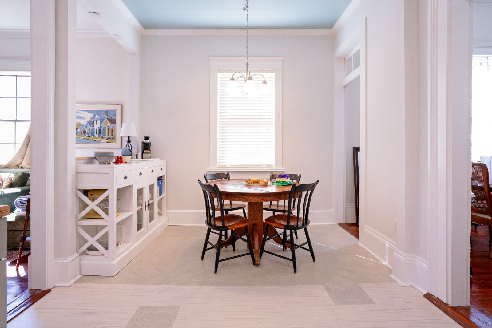 Dining room with painted blue ceiling and crown molding