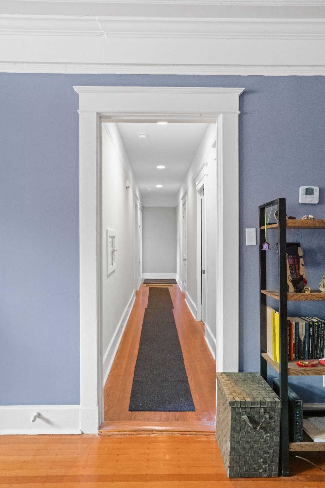 Renovated hallway with recessed lighting and hardwood floors