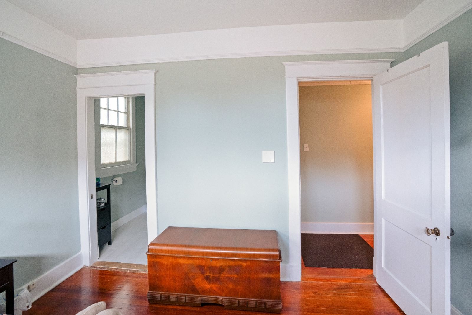 Master bedroom with ornate crown molding and hardwood floors