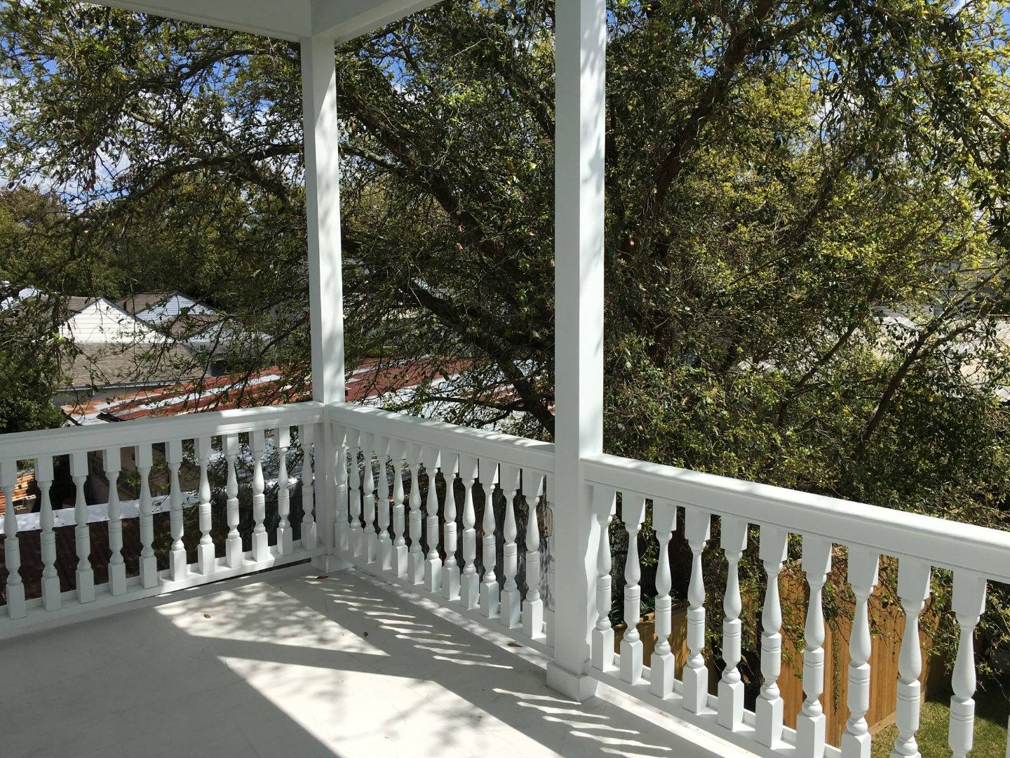 Open plan living renovation with vaulted skylight, warm hardwood floors and French door entry