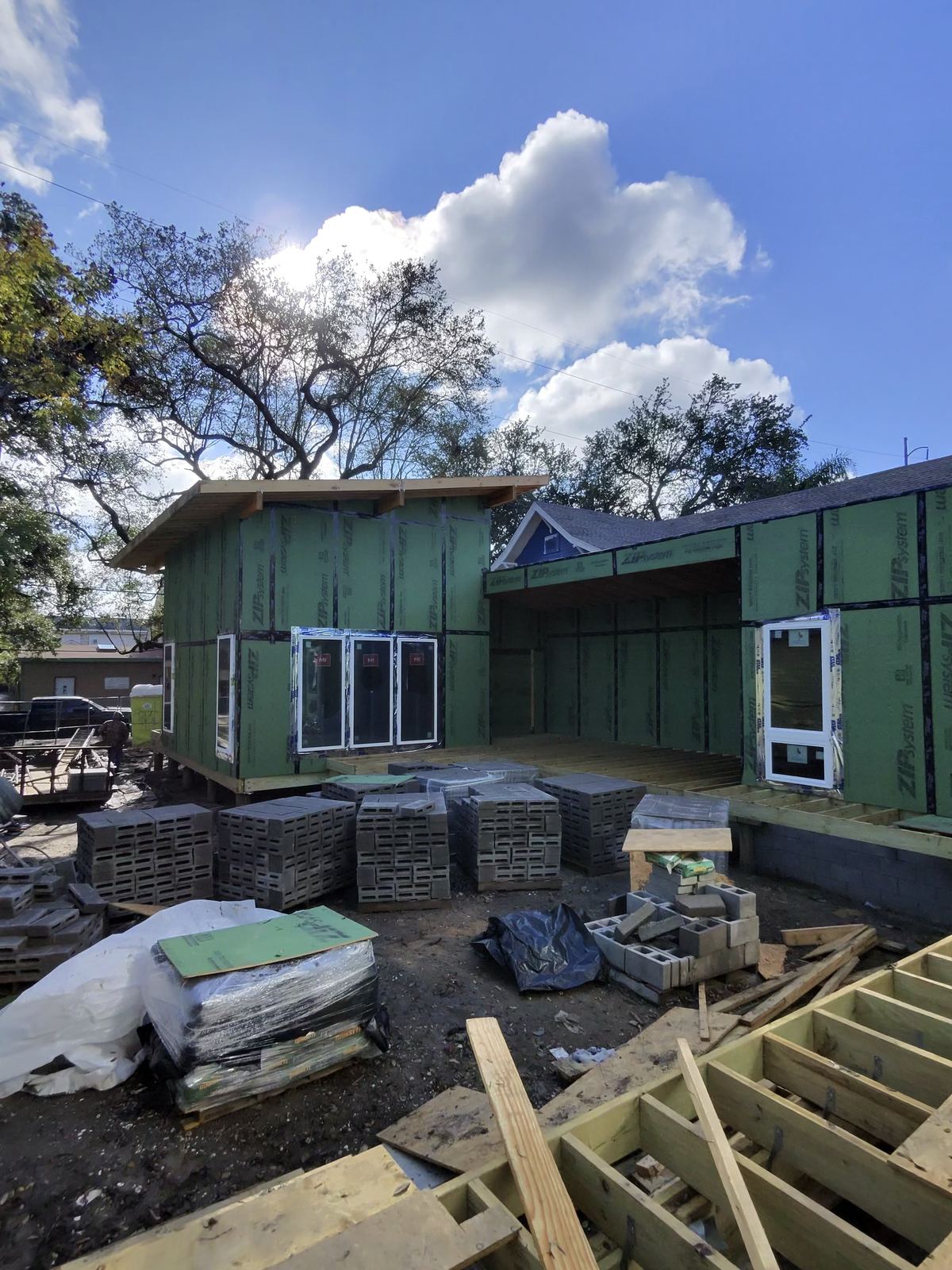Modern ADU addition under construction with ZIP system sheathing and metal roof taking shape