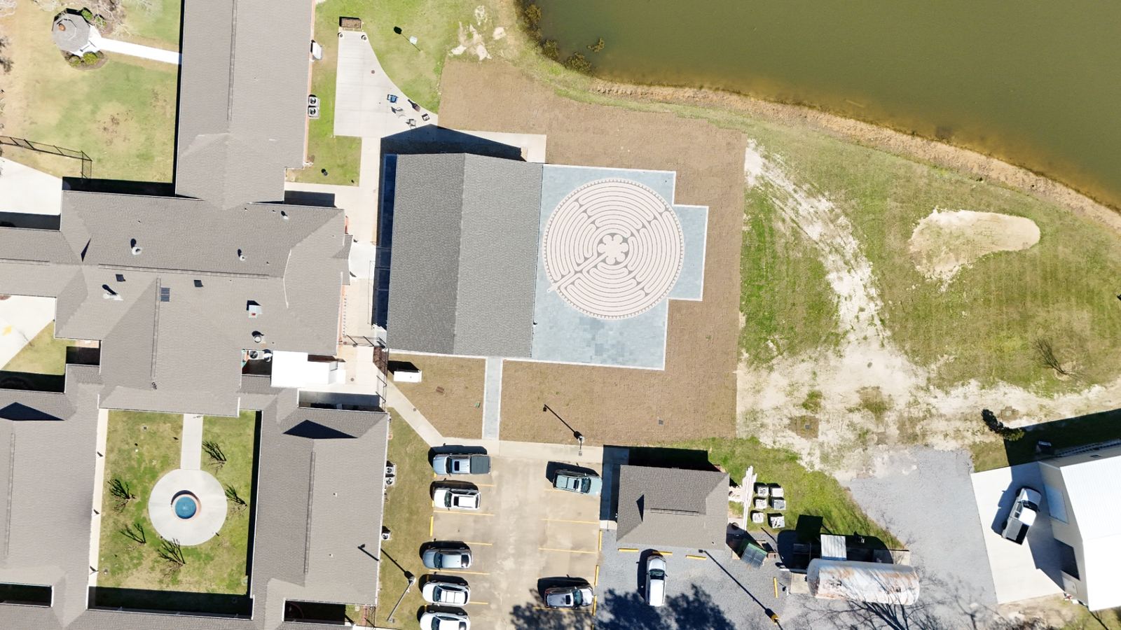 Completed new construction cream house with custom pergola and covered porch