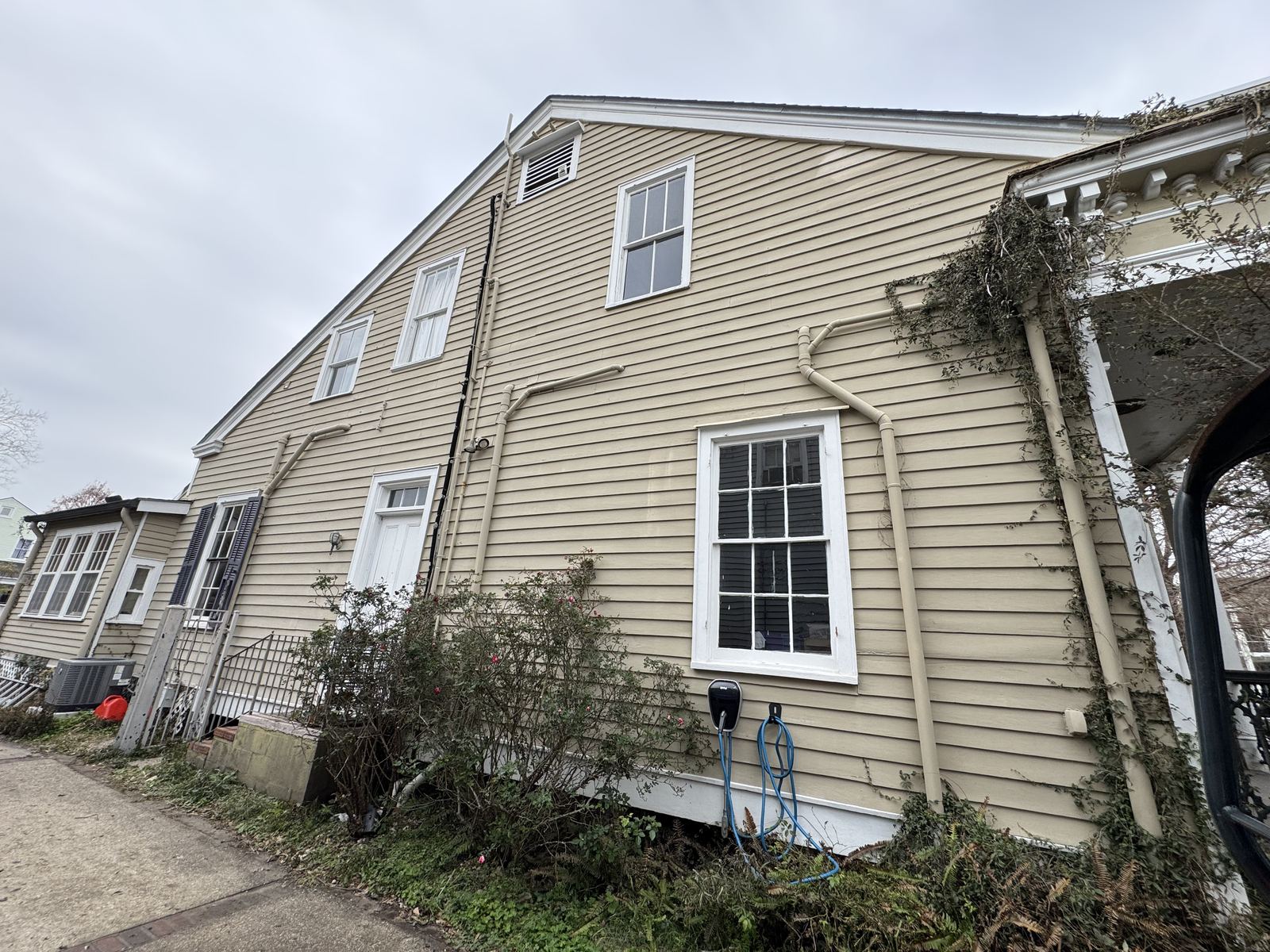 Modern ADU under construction with vertical cedar siding and oversized windows