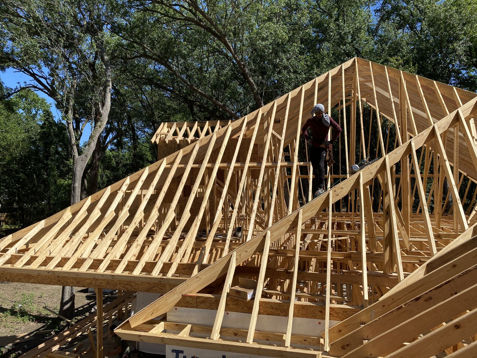 Green Terra crew framing custom multi-gable roof on new construction home