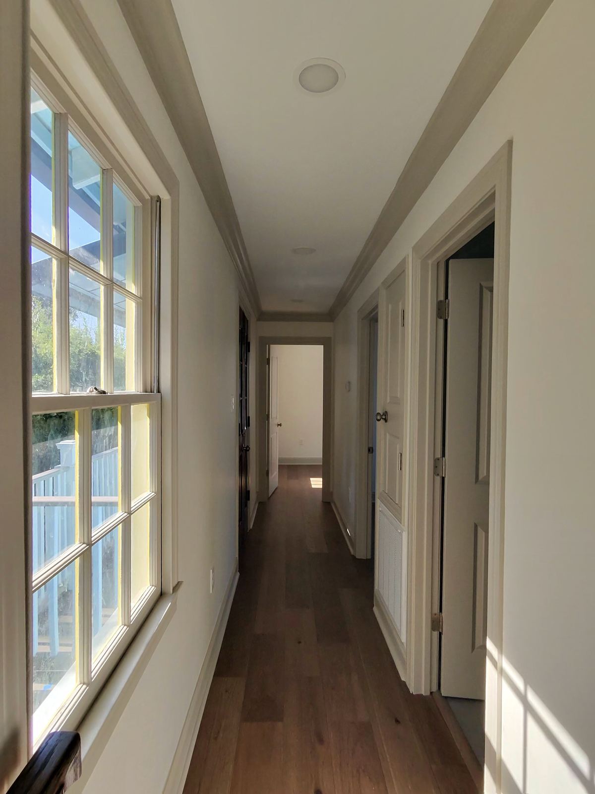 New construction master bedroom with vaulted ceiling exposed beams and black casement windows