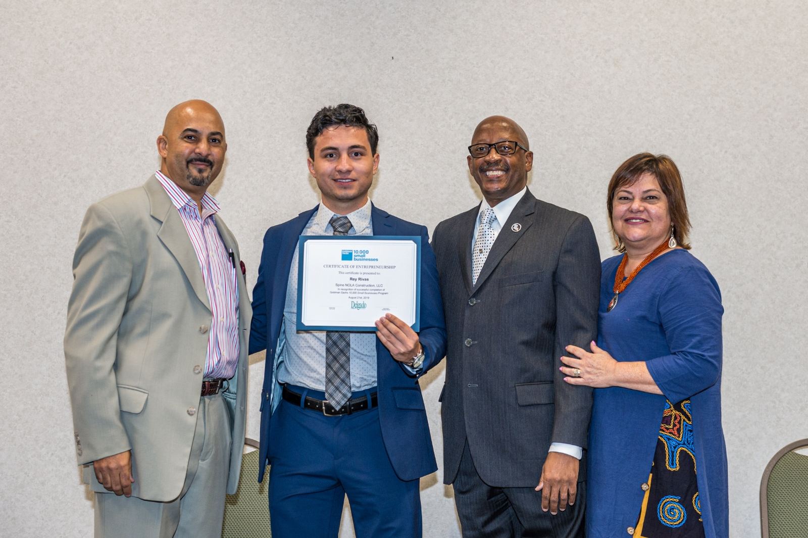 Rey Rivas receiving Goldman Sachs 10,000 Small Businesses certificate