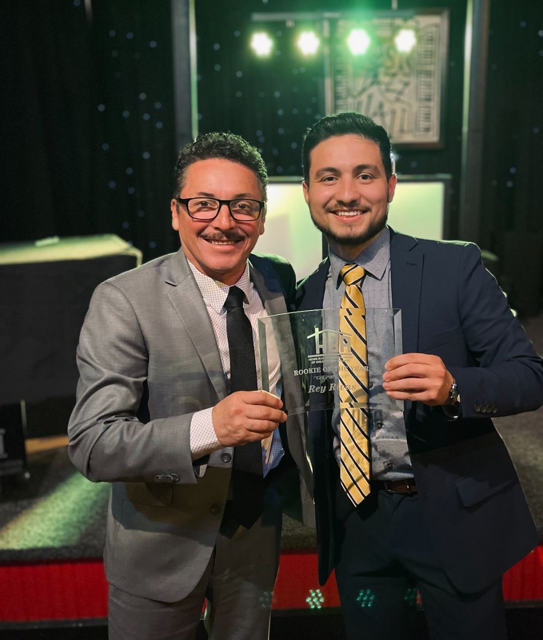 Rey Rivas and Esteban Rivas holding the HBAGNO Rookie of the Year award