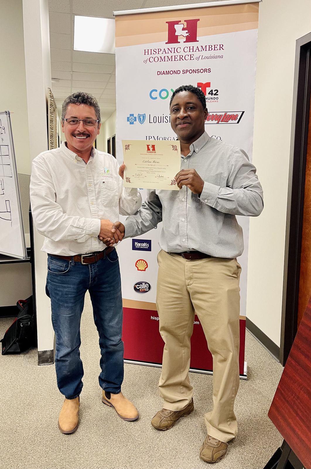 Esteban Rivas receiving certificate from Hispanic Chamber of Commerce of Louisiana